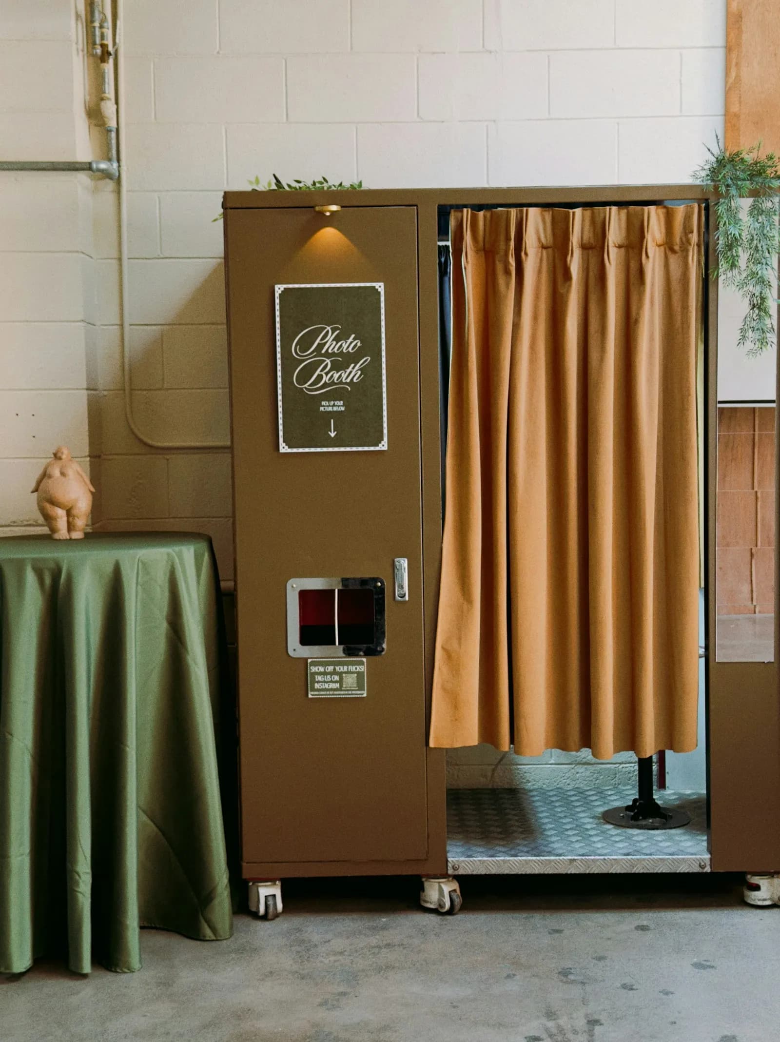 A vintage photo booth with a tan curtain