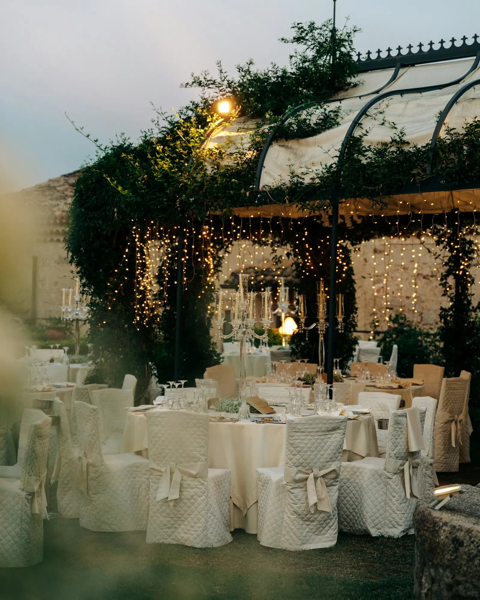 Round reception tables dressed in white linen